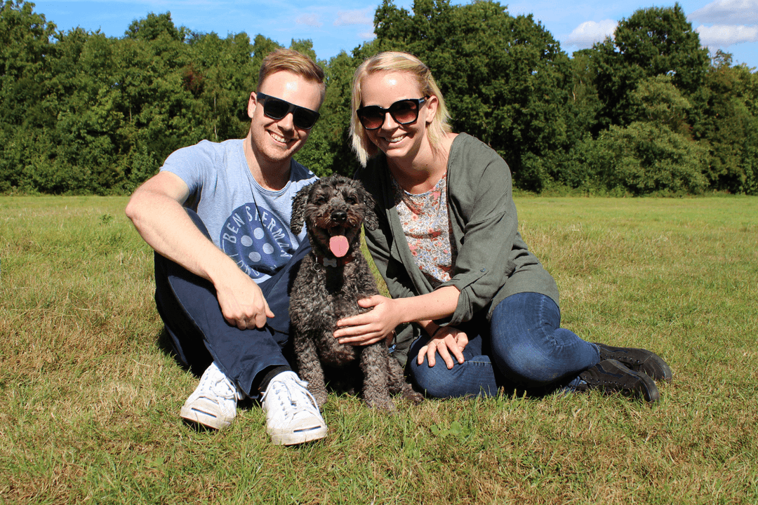 A couple sitting with a dog