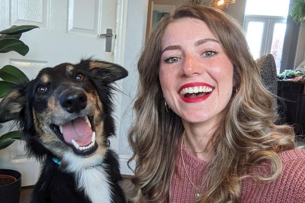 Frank the Cross Breed with his borrower, both have huge grins on their face.