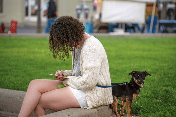 A Woman on her Phone ignoring her dog